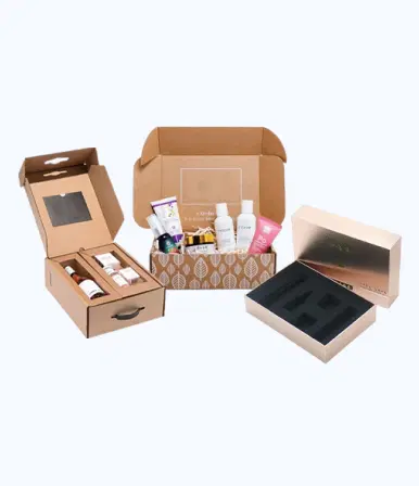 Three cosmetic packaging boxes: a brown kraft cardboard box with handle and window containing glass bottles with droppers, a light brown corrugated box with leafy pattern interior filled with various cosmetic products, and a rose gold rigid box with custom foam insert