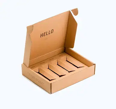 Open light brown corrugated cardboard shipping box with custom-fit insert creating four separate compartments, each containing a smaller rectangular light brown box labeled 'FOCUS', 'ELEVATE', 'RELIEF', and 'RELAX' with 'HELLO' printed on the inner flap