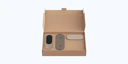 Open shallow rectangular brown corrugated box with custom cardboard inserts holding three electronic devices