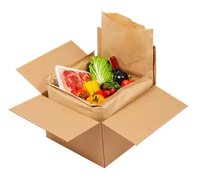 Open light brown corrugated cardboard shipping box with cardboard insert tray containing fresh food items including meat, vegetables, peppers, tomatoes, and a wine bottle