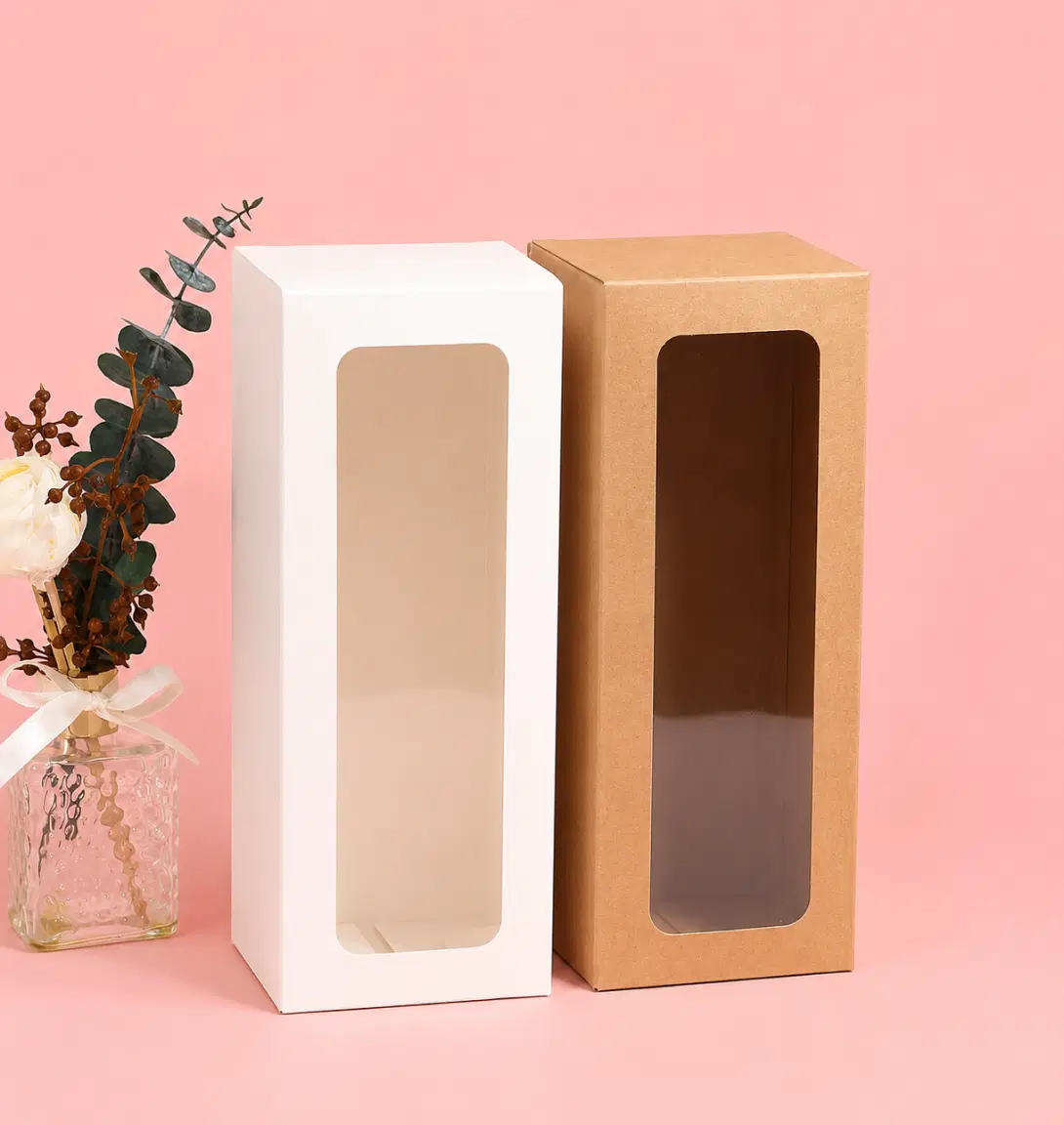 Two identical light brown cardboard boxes with clear plastic windows